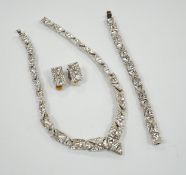 A suite of white paste set jewellery, comprising a necklace, bracelet and pair of earrings, in a