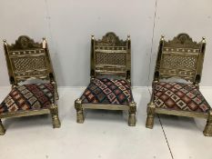 Three Indian metal clad Pidha low chairs with enamelled decoration and Kilim covered seats, width