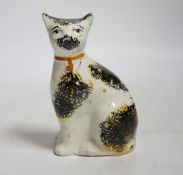 A Staffordshire pottery cat with yellow collar, mid 19th century, height 9.5cm