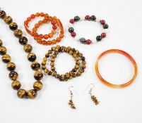 A tiger's eye quartz bead necklace, 44cm and two tiger's eye quartz bracelets, together with other