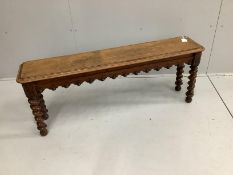 A Victorian oak window seat on spiral turned legs, width 122cm, depth 25cm, height 47cm