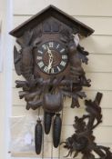 A Black Forest cuckoo clock with double cuckoo, approximately 30cm high