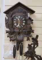 A Black Forest cuckoo clock with double cuckoo, approximately 30cm high