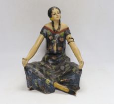 An Austrian painted terracotta figure of a seated girl, 27cm high