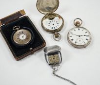 Three silver pocket watches and a travel timepiece.