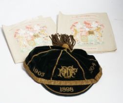 Two South African late 19th century damask railway napkins and a velvet rugby or cricketing cap