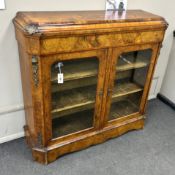 A mid Victorian tulip banded and gilt metal mounted figured walnut two door glazed side cabinet,