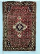 A North West Persian red ground rug, 206 x 141cm