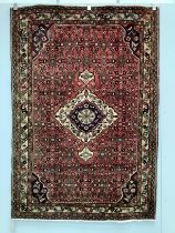 A North West Persian red ground rug, 206 x 141cm