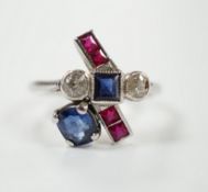 An unusual 1920's/1930's platinum, ruby, sapphire and diamond cluster set dress ring, of free