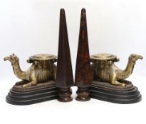 A pair of camel and obelisk side ornaments raised on tapered bases, 51cm high