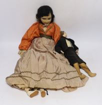 A continental 1920’s cloth doll, together with a smaller wax headed doll