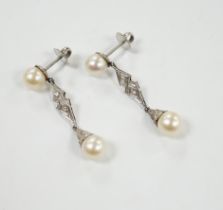 A pair of white metal, two stone cultured pearl and two stone diamond chip set drop earrings,