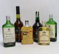 Two 75cl bottles of Gordons gin, two 35cl bottles of whisky, a bottle of sherry and a bottle of