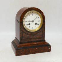 A late 19th century French rouge marble mantel clock, striking on a bell, with key, 24cm high