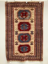 A Caucasian style fawn ground rug, 200 x 132cm