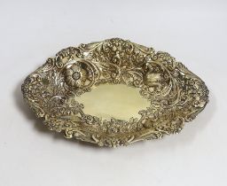 A late Victorian embossed silver gilt oval dish, by Charles Stuart Harris, London, 1886, 27cm, 8.