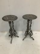 A pair of Victorian style circular cast metal tripod tables, diameter 36cm, height 72cm
