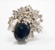 A mid to late 20th century 18k white metal, single stone oval cut sapphire and baguette and round