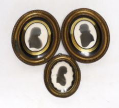 Three late Georgian silhouette portraits, verre eglomise mounts, largest 17cm high