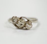 An 18ct, plat and three stone old mine cut diamond set crossover ring, size N, gross weight 2.3