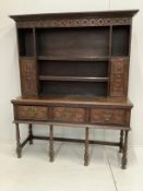 An 18th century style carved oak dresser, width 151cm, depth 49cm, height 191cm