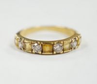 A yellow metal, five stone square cut yellow sapphire and four stone round cut diamond set half hoop