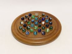 A solitaire board with glass marbles, board 25cm in diameter