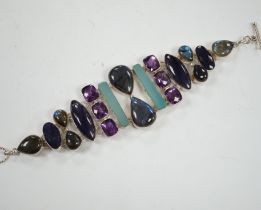 A white metal and multi gem set bracelet, including dyed agate, amethyst and labradorite, 21cm.