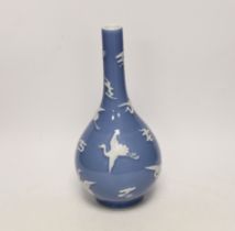 A Chinese blue bottle vase decorated in relief with cranes, on stand, 32cm high overall