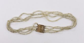 A Regency four (ex five) strand seed pearl choker necklace, with rectangular engraved yellow metal