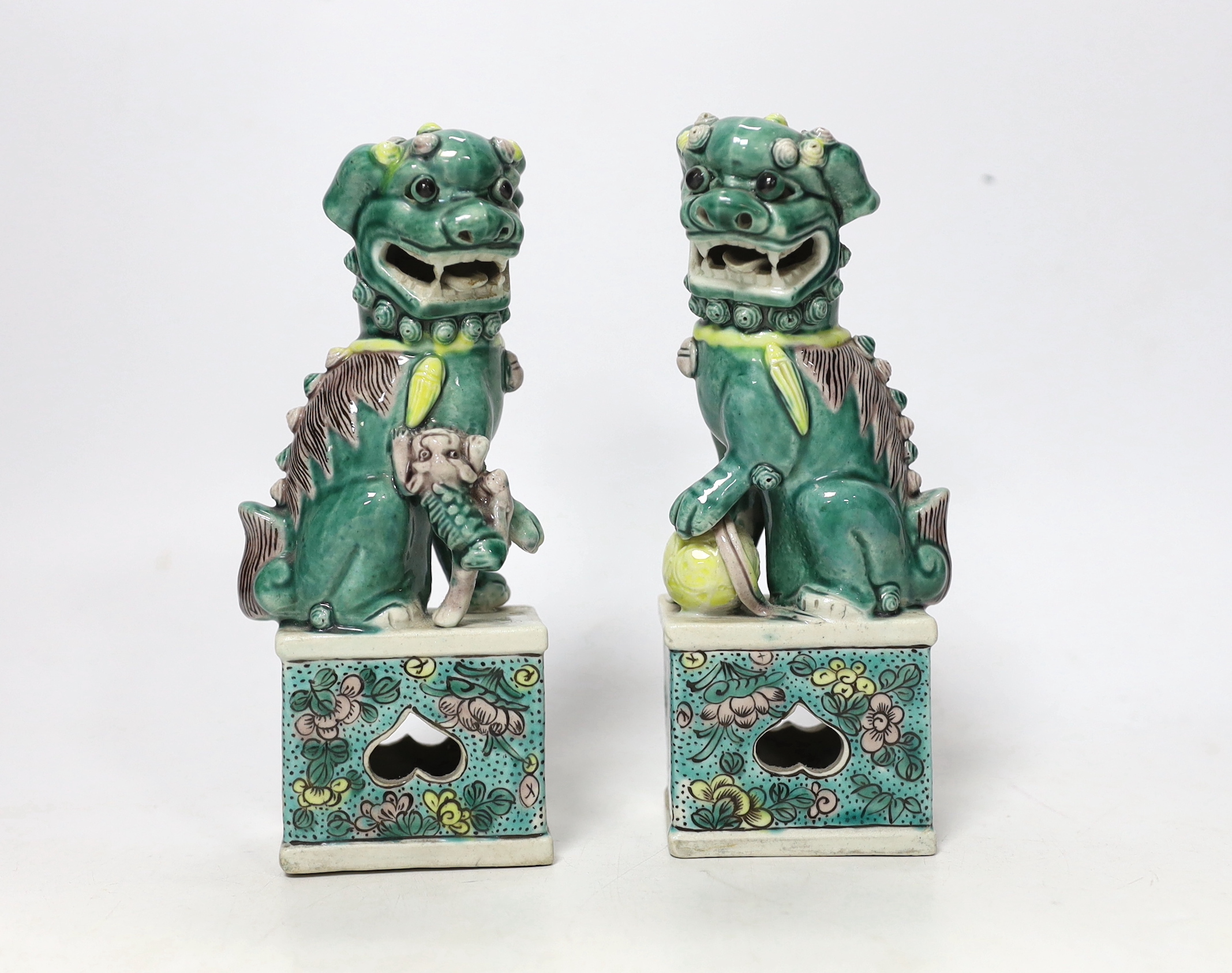 A pair of small early 20th century Chinese figures of Buddhist lions, 15.5cm high