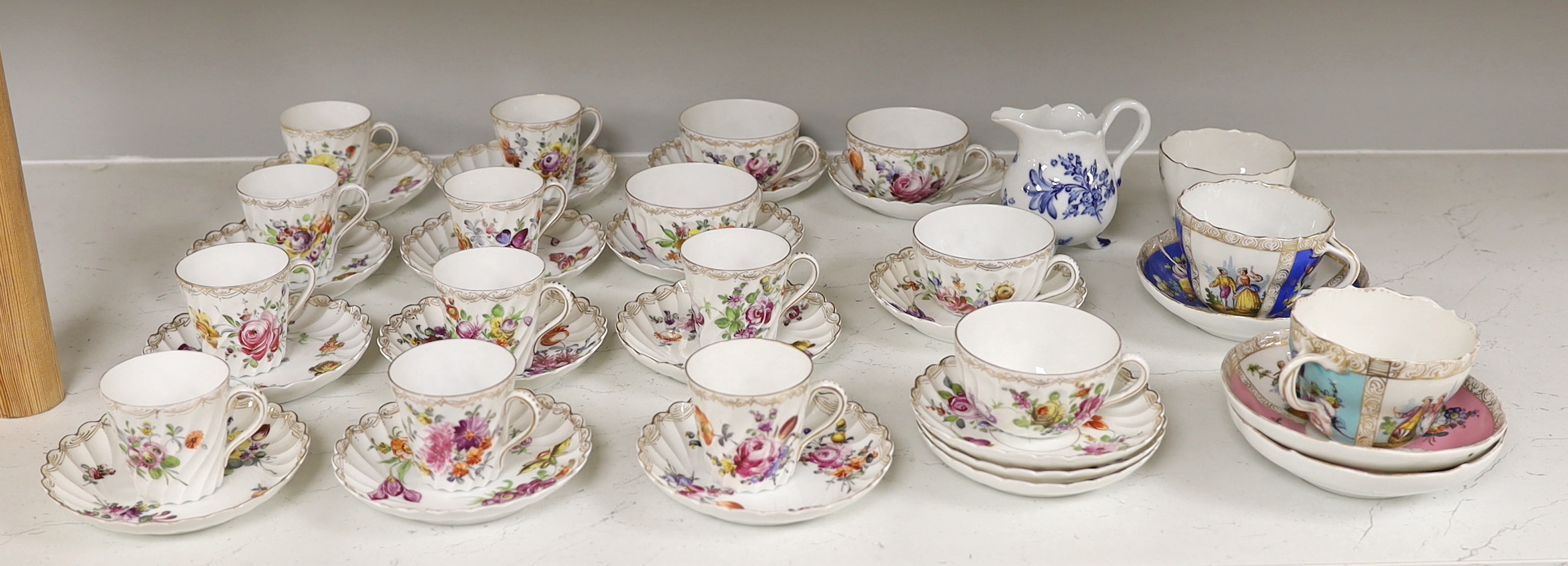 A group of porcelain Dresden tableware including cups and saucers and a blue and white jug