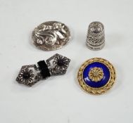 A George V silver thimble, a later silver brooch, a white metal, marcasite and black onyx brooch and