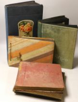 Three albums of Edwardian and later postcards and two early 20th century photograph albums,