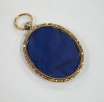 An engine turned yellow metal oval mourning locket, verso with small glazed oval panel, 56mm.