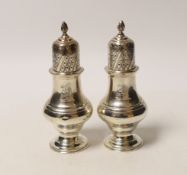 A matched pair of George V silver pepperettes, Chester 1912 and London, 1913, 12.3cm, 4.3oz.