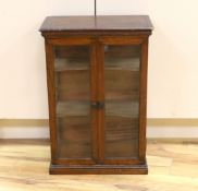 A small early 20th century glazed oak and pine two door shop display cabinet, 65.5 x 45 x 26cm