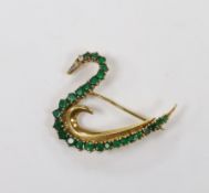 A late 1980's 18ct gold, emerald, and diamond cluster set brooch, modelled as a swan, with trapeze