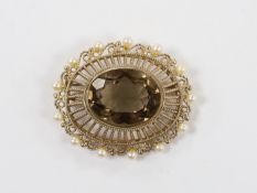 A Zeeta 9ct and oval cut yellowy brown quartz set pendant brooch, with cultured pearl set border,