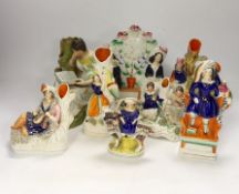 An early 19th century Staffordshire pearlware figure of a seated lady and seven mid 19th century