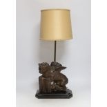 An 18th century oak carving of a Heraldic lion, now as a lamp, 55cm high including shade