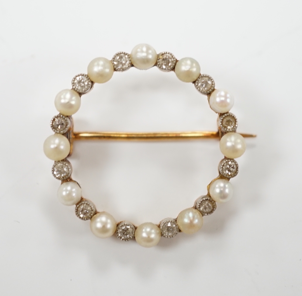 An Edwardian yellow metal, seed pearl and diamond chip set circular open work brooch, 22mm, gross