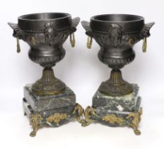 A pair of late 19th century French gilt metal and brown patinated urns, decorated with masks and