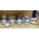 A Wedgwood Florentine part dinner set including twin handled cups, oval platter and dinner plates,