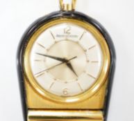 A gilt metal and black enamel Jaeger LeCoultre horseshoe shaped travelling timepiece, 45mm.