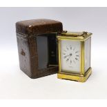 A Curtis brass carriage timepiece, in leather case, 15cm high