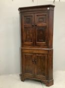 A George III oak standing corner cupboard, width 97cm, depth 46cm, height 197cm