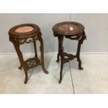 A near pair of Chinese circular rouge marble topped hardwood jardiniere stands, largest diameter