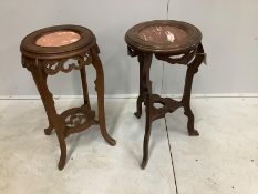 A near pair of Chinese circular rouge marble topped hardwood jardiniere stands, largest diameter